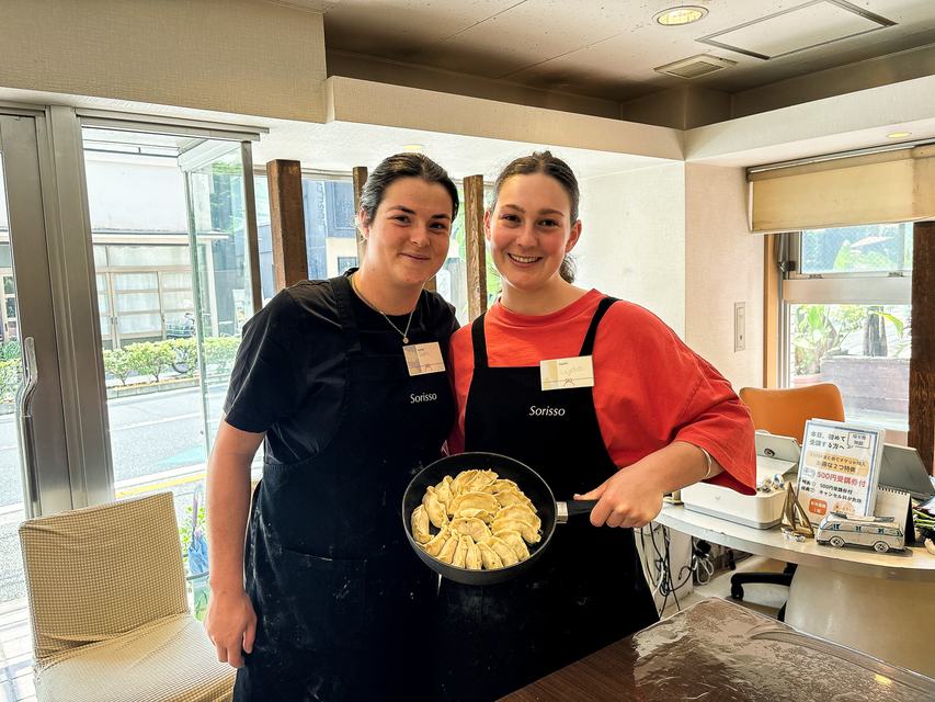Two guests with a pan of handmade gyoza