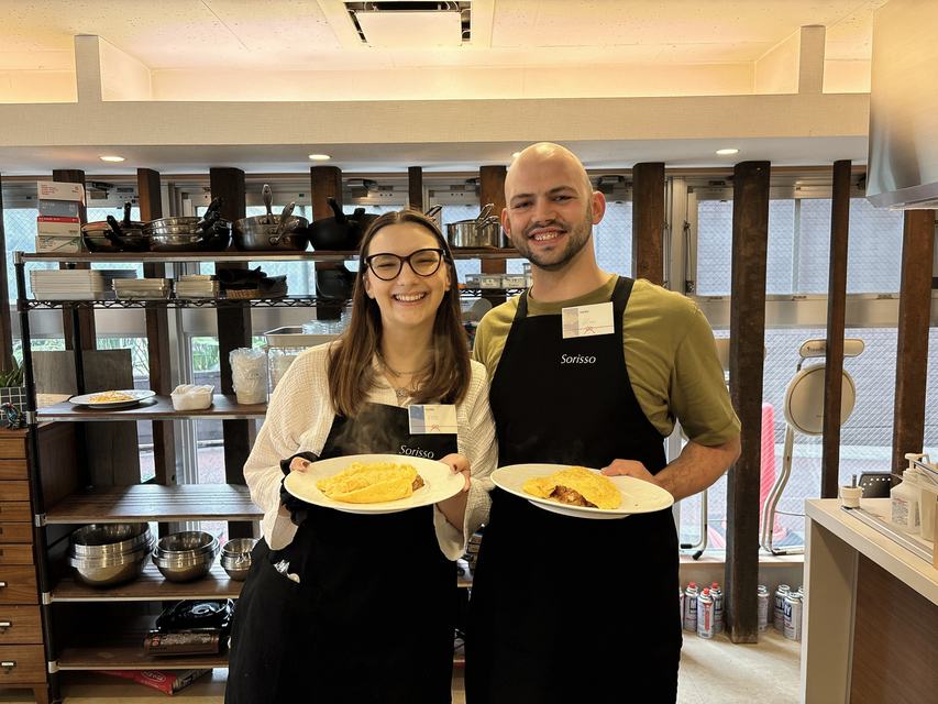 Guests smiling with the omurice they made