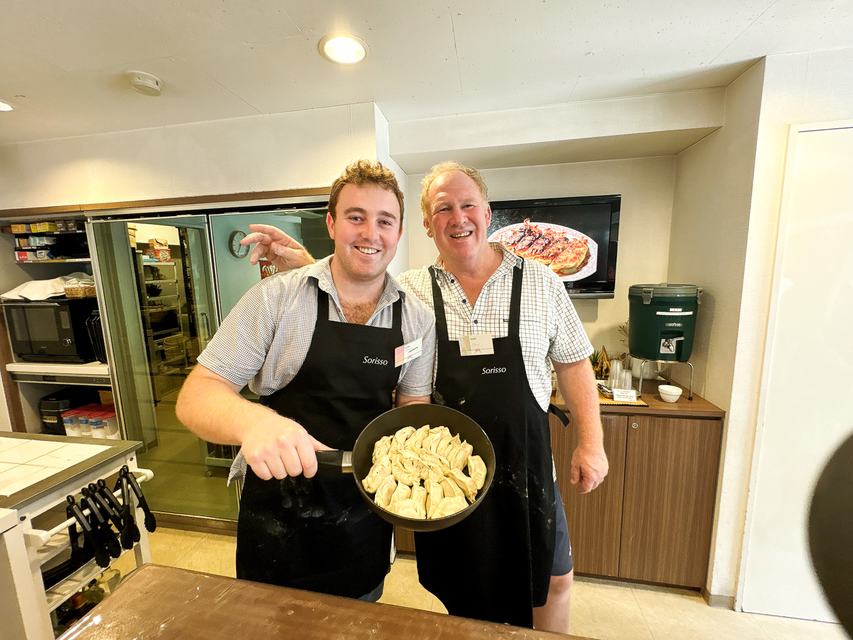 Two guests with a pan of gyoza