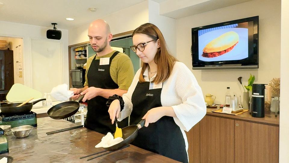 Guests cooking omelets for omurice