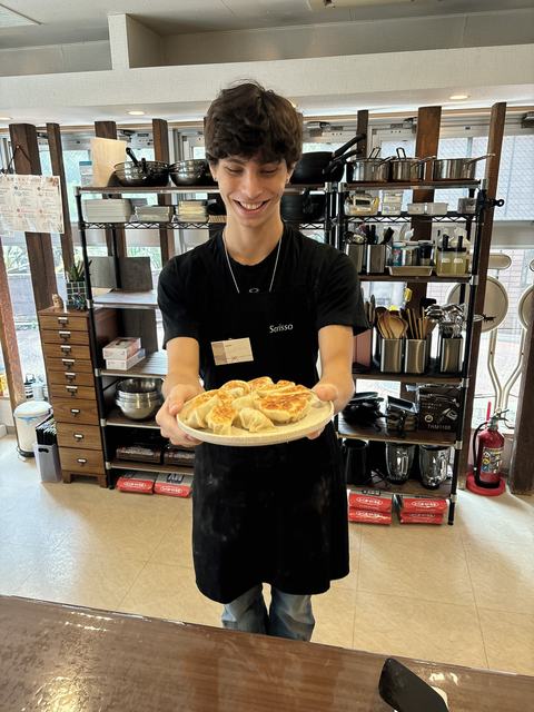 A guest proudly holding his gyoza