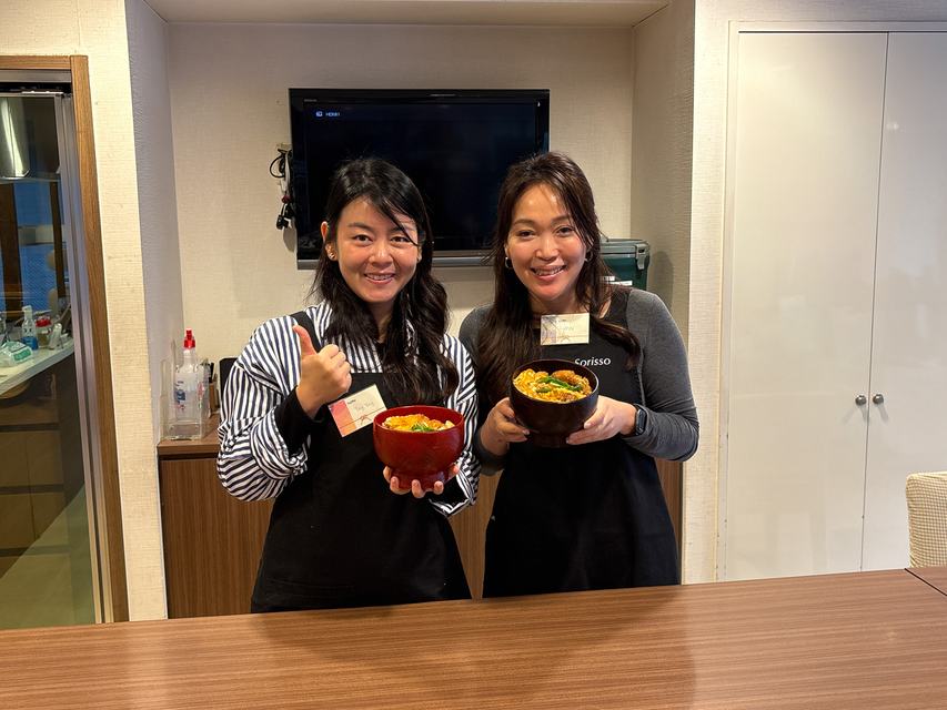 Two guests with the katsudon they made