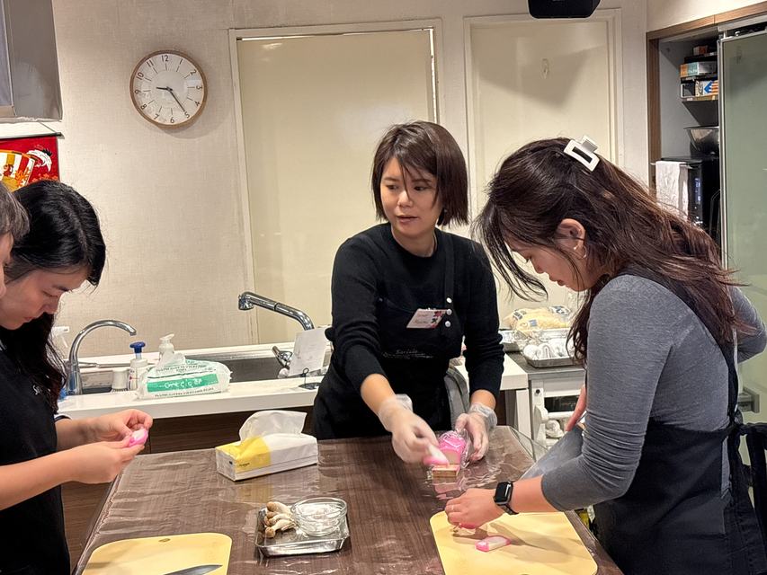 An instructor guiding guests as they prepare ingredients