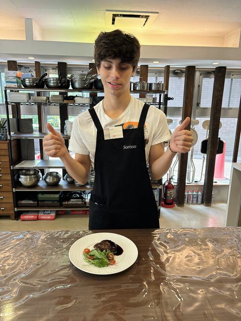 A guest giving a thumbs-up to his hamburg steak